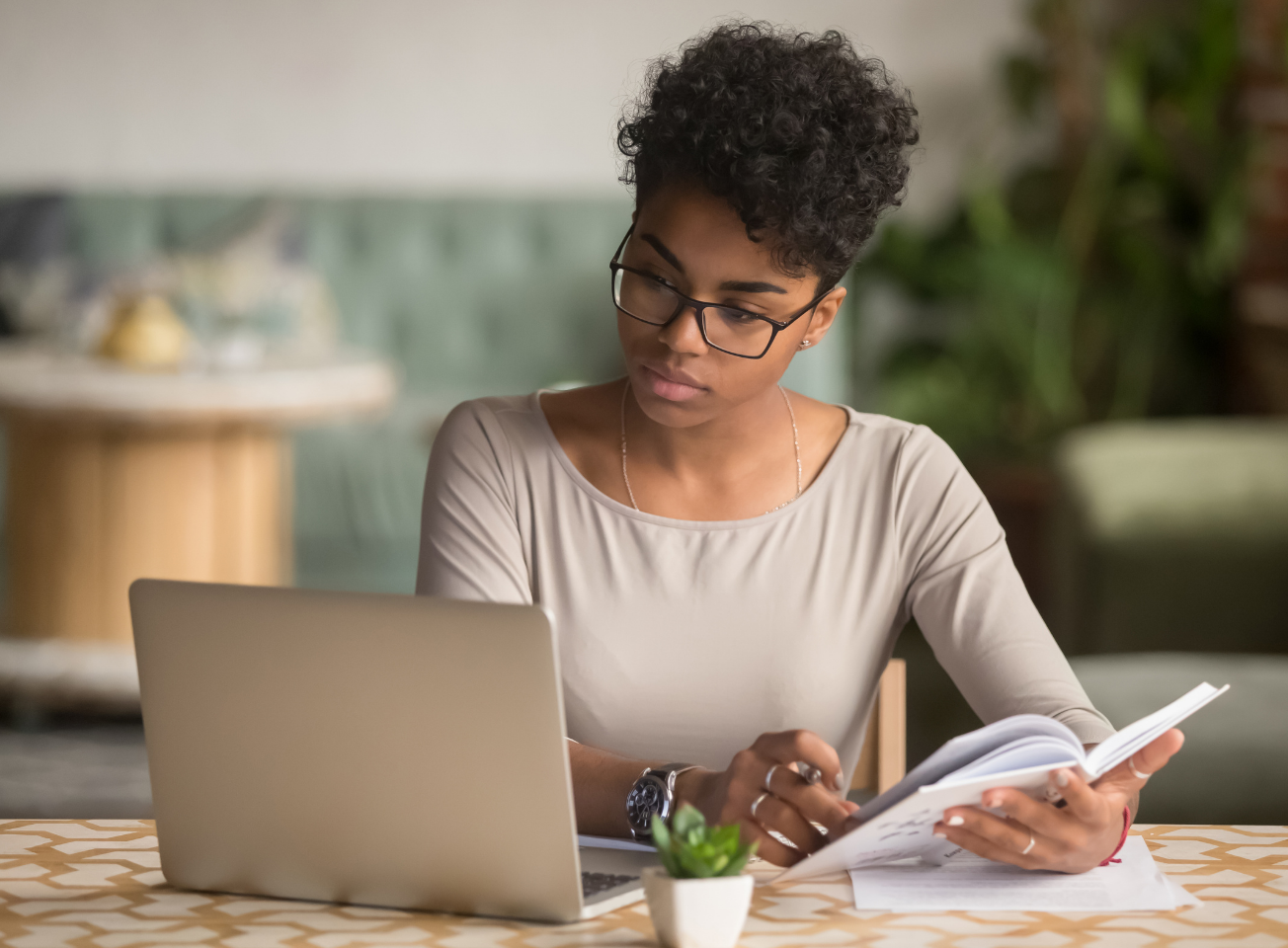 A researcher at her laptop with a notebook